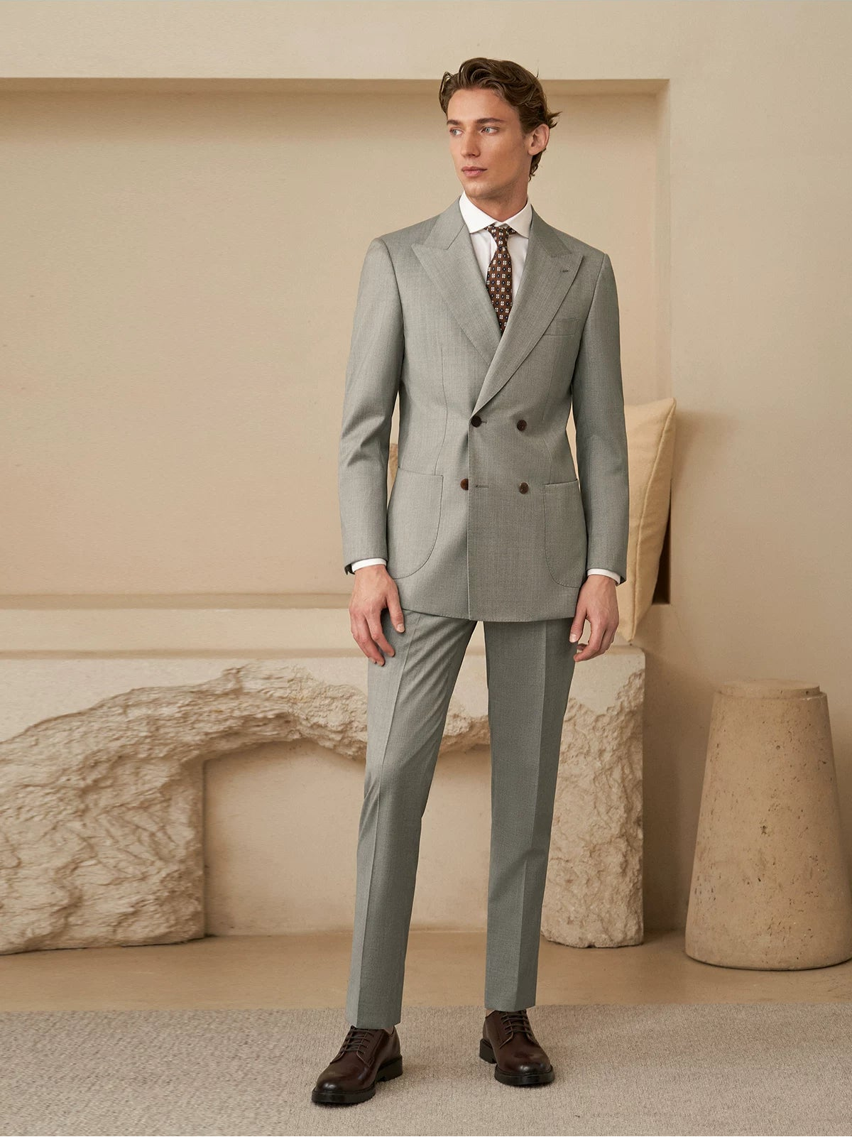 Full-length side view of model in Neapolitan VBC Super 110s wool suit in haze of olive groves — From Borcelleclothes.