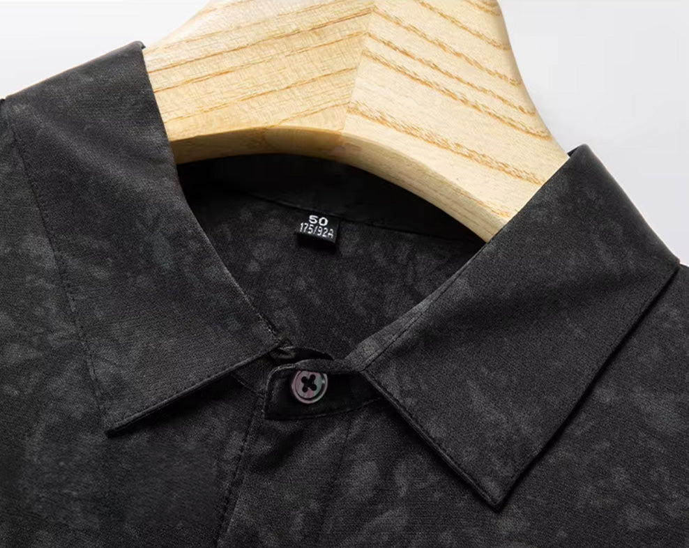 Sharp macro shot of the structured pointed collar on the men's black Mulberry silk shirt, highlighting the deep tones of the organic print — From Borcelleclothes.