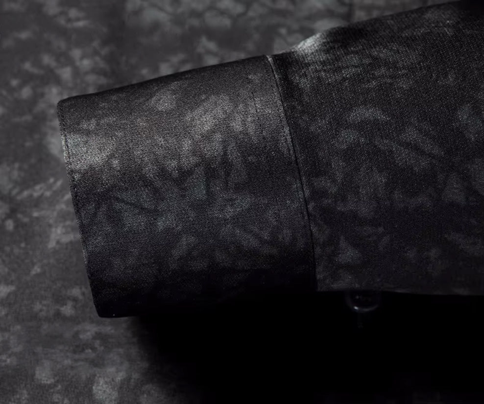 A precise close-up of the tailored single-button cuff on the long sleeve of the black Noctis Labyrinthus silk shirt — From Borcelleclothes.