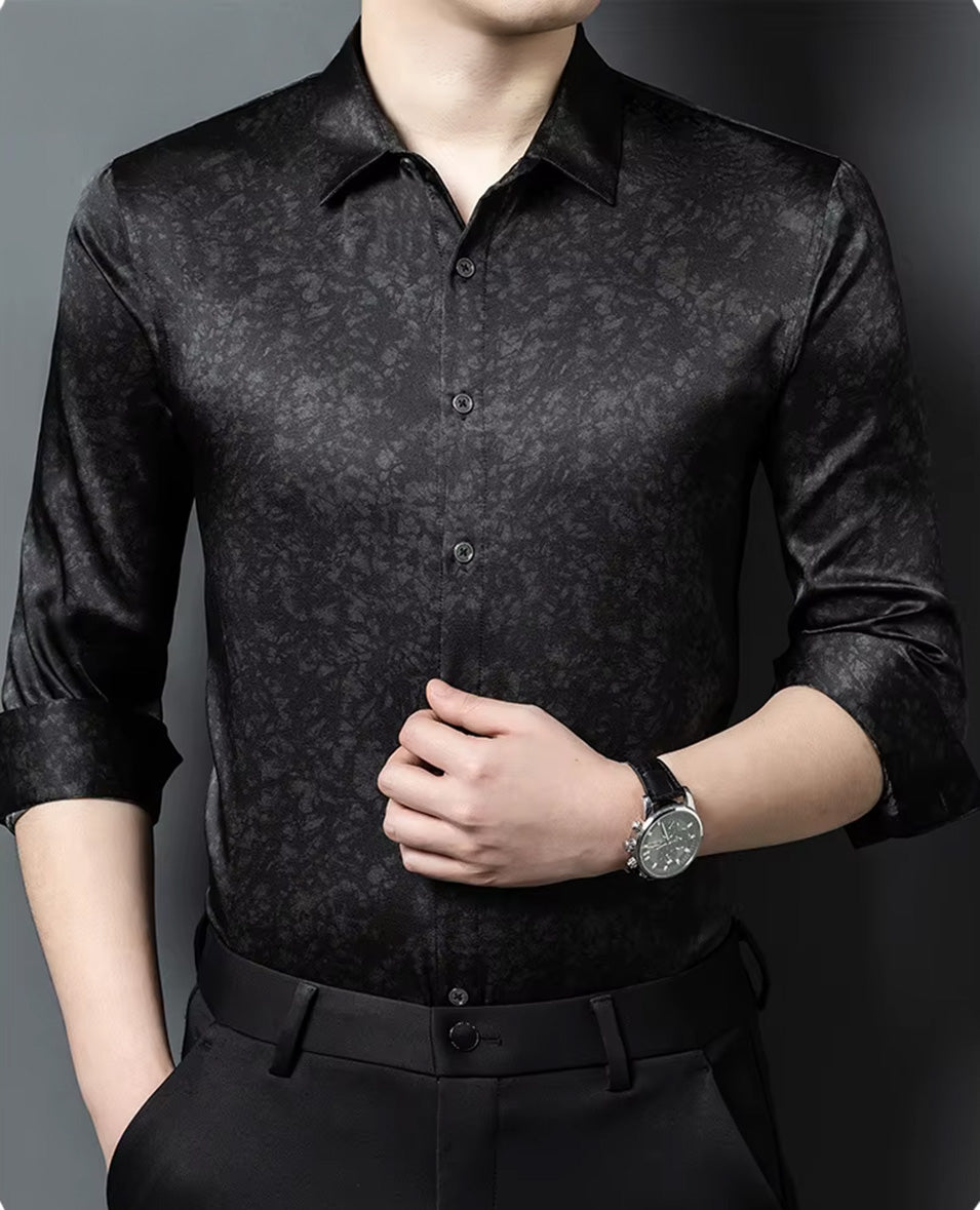 Close-up of a man adjusting the clean front placket of his luxury black Mulberry silk shirt, emphasizing the fluid movement of the fabric — From Borcelleclothes.