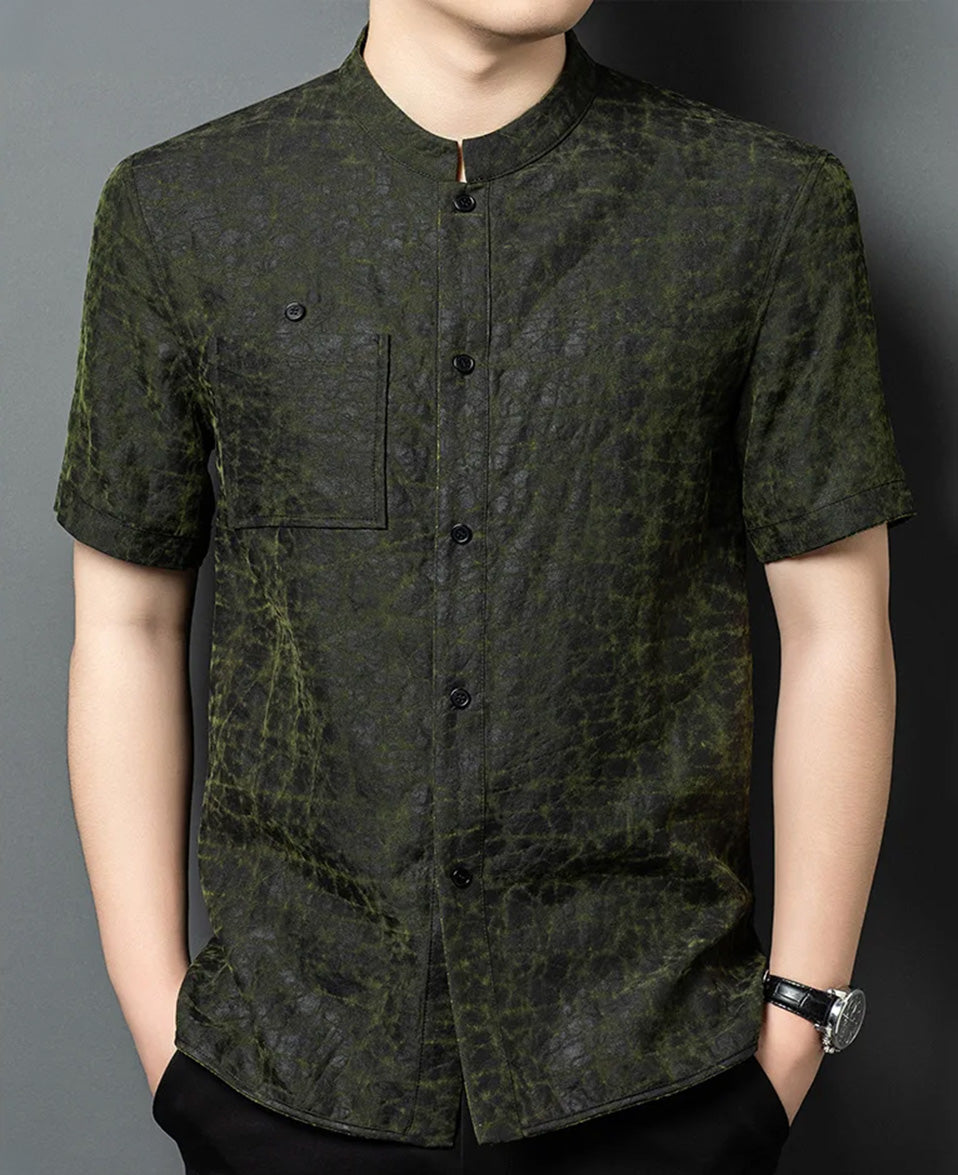 Front view of a man posing with hands in pockets, wearing the reversible shirt-jacket on its solid matte-black mineral-fermented side — From Borcelleclothes.