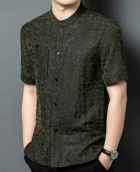 A men's reversible shirt-jacket worn on the solid black face, showcasing a structured silhouette from a slight side angle with deep matte-graphite silk texture — From Borcelleclothes.