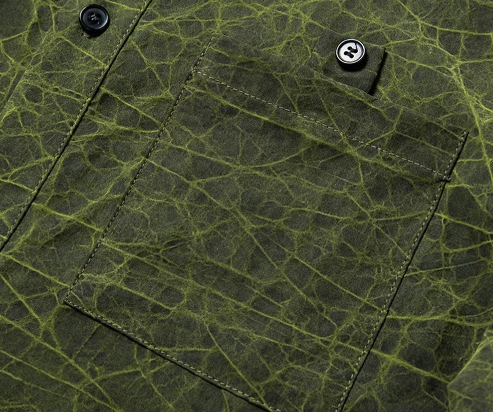 Close-up of the chest patch pocket on the Chartreuse Glow face, featuring the decorative stitched button tab and natural mineral fissures — From Borcelleclothes.