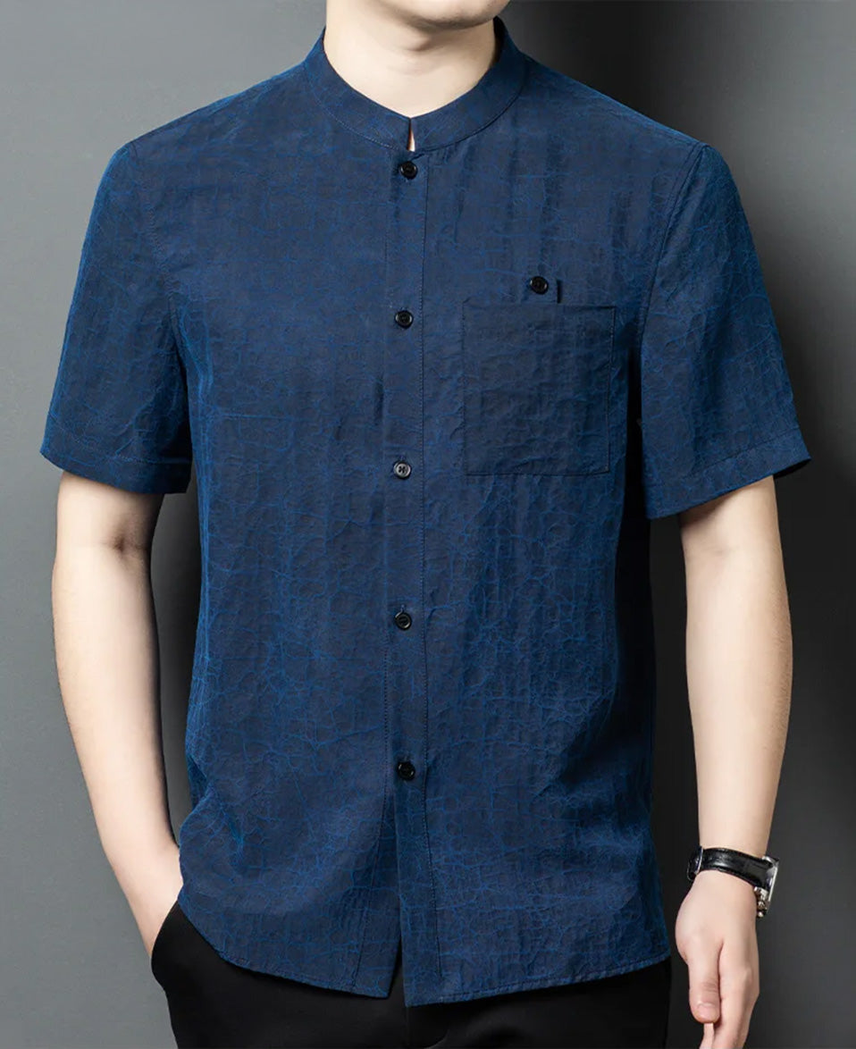 Front view of a man with one hand in his pocket, wearing the shirt-jacket on the Neon Indigo side, highlighting the deep blue structural coloration — From Borcelleclothes.
