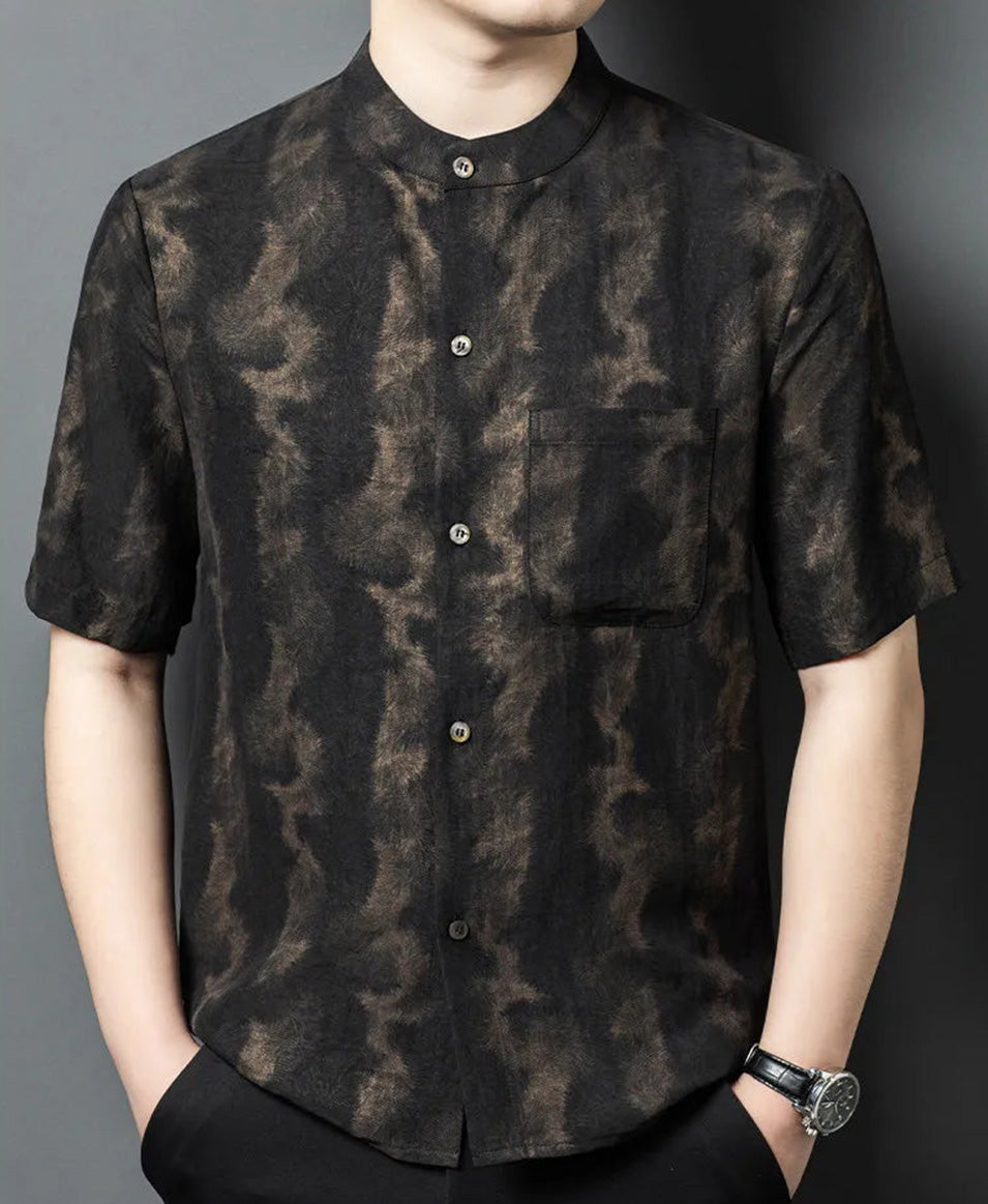 Men's Xiangyunsha silk shirt in Rutilated Graphite color, featuring a band collar and a unique handmade needle-like amber pattern, on a model with hands in trousers pockets — From Borcelleclothes.