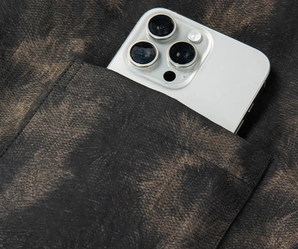 Shirt pocket detail with a phone on Men's Xiangyunsha silk shirt in Rutilated Graphite color, showcasing the unique handmade pattern — From Borcelleclothes.