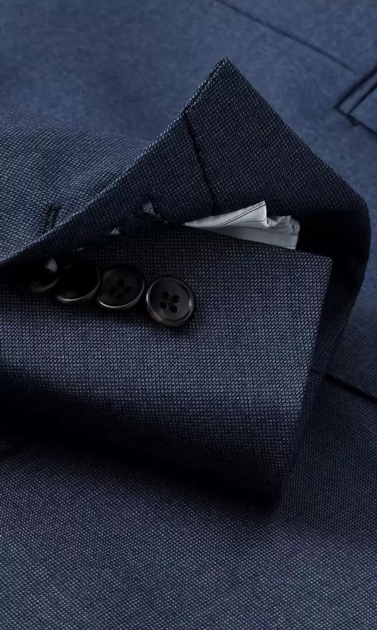 Close-up of functional surgeon's cuffs with genuine horn buttons unfastened on the Salt Wave suit sleeve — From Borcelleclothes.