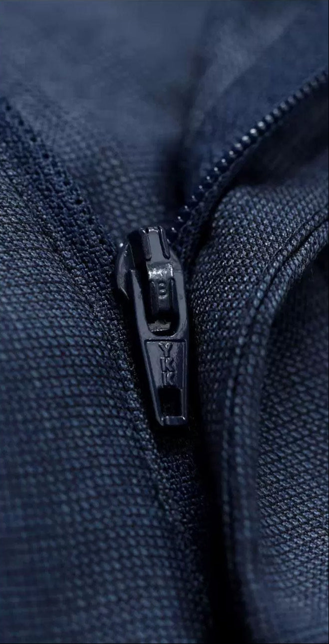 Macro detail of the front fly closure featuring a tailored metal zipper on Salt Wave wool trousers — From Borcelleclothes.