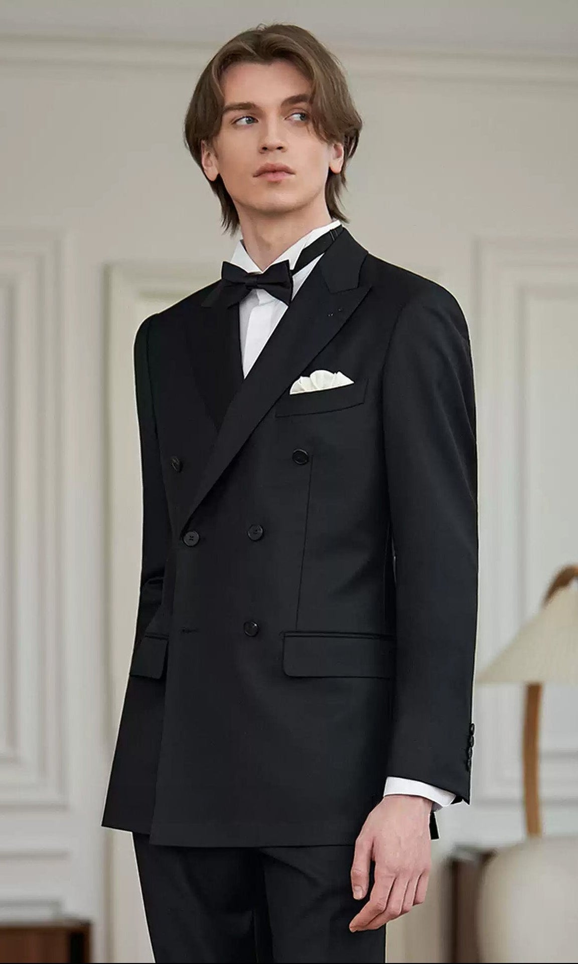 Side-angle view of a male model wearing the Pianissimo double-breasted suit in VBC wool, highlighting the natural shoulder roll and structured waistline — From Borcelleclothes.