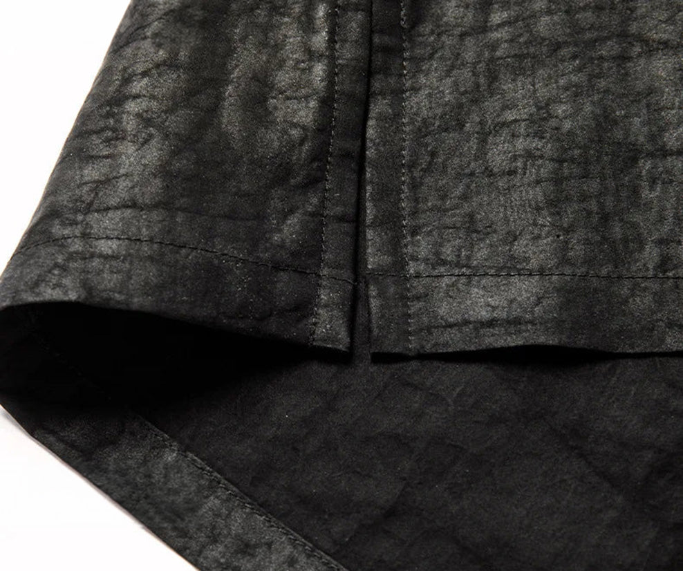 Detailed view of the clean side slit and hemline of the men's polo — From Borcelleclothes.