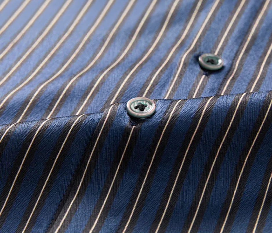 Macro shot of the premium buttons on the front placket of the men's striped herringbone silk shirt in Burning the Midnight Oil — From Borcelleclothes.