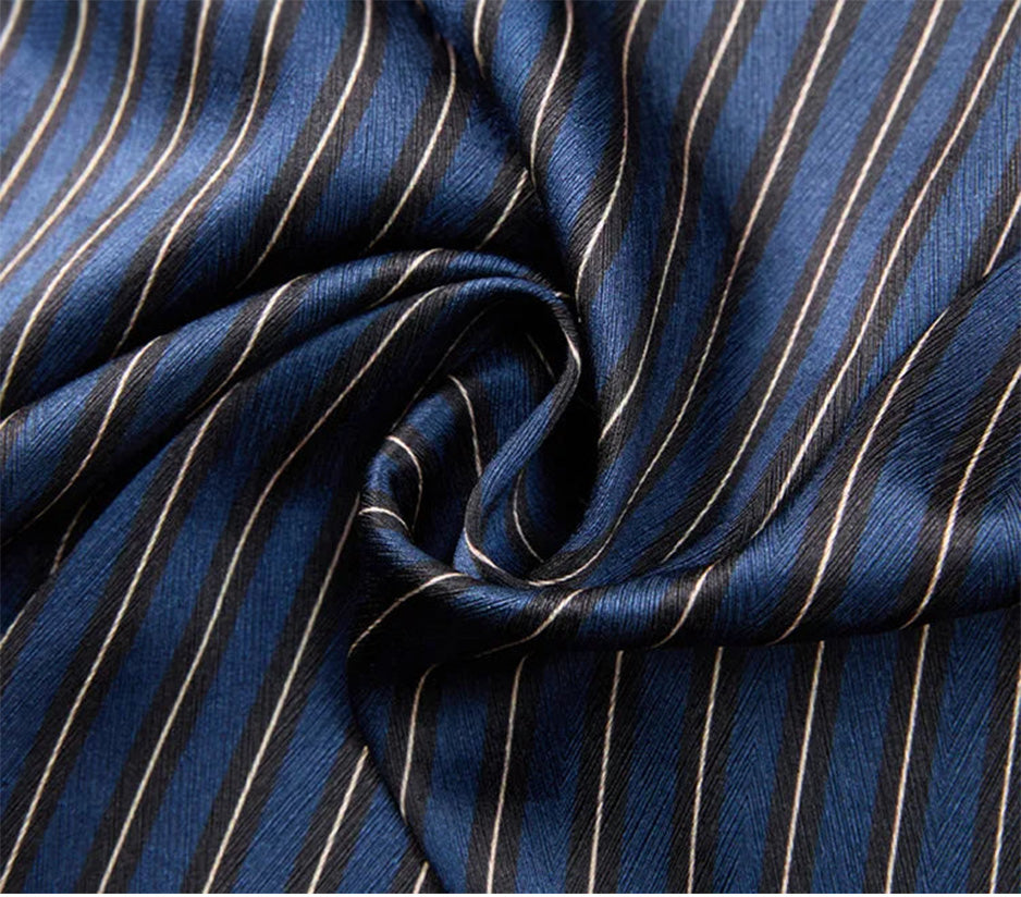 Close-up of the heavy Mulberry silk in Burning the Midnight Oil, spiral-folded to highlight the rich herringbone weave and geometric stripe texture — From Borcelleclothes.