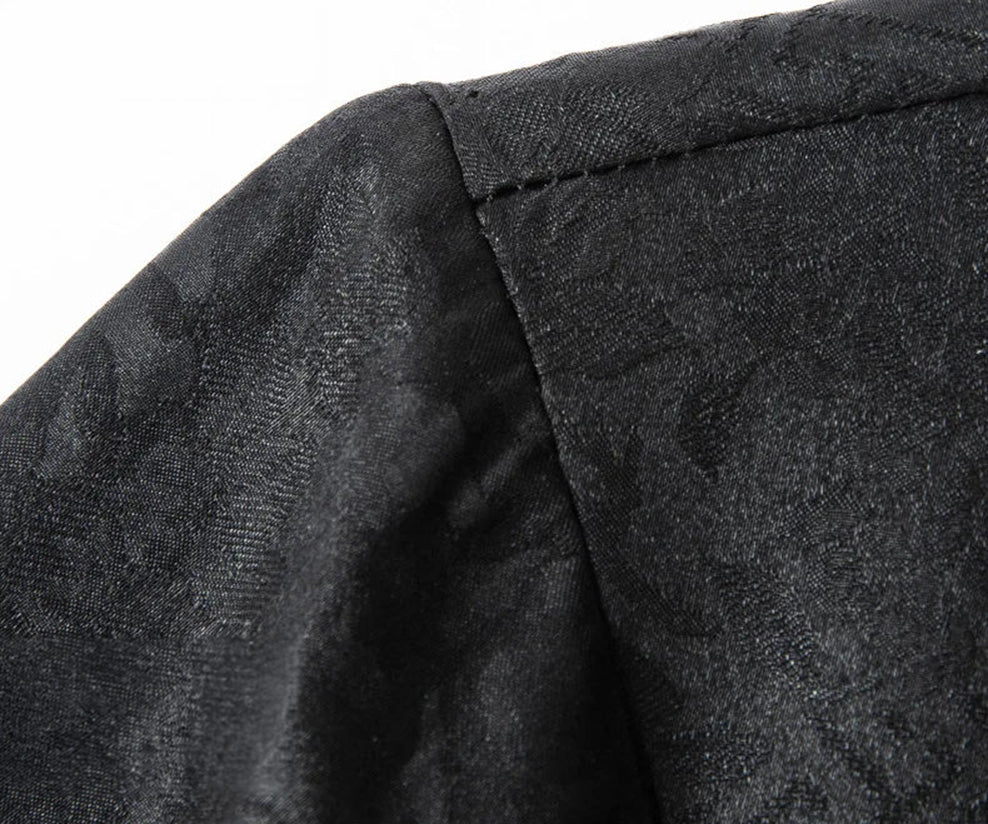 Sharp macro shot of the dropped shoulder architecture on the men's silk shirt-jacket, showing the seamless integration of the elusive meander pattern across the seams. — From Borcelleclothes.