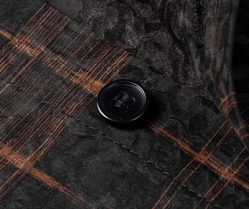 Premium button fastened onto the front placket of a men's graphite jacquard silk shirt with a cognac check weave, from Borcelleclothes.