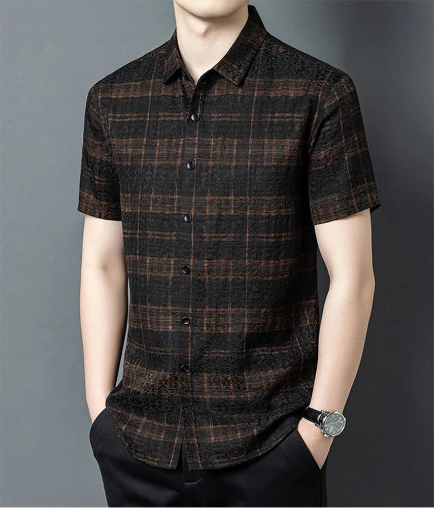 Men's buttoned graphite jacquard silk shirt with a structural cognac check framework, worn by a man with hands in trousers pockets, from Borcelleclothes.