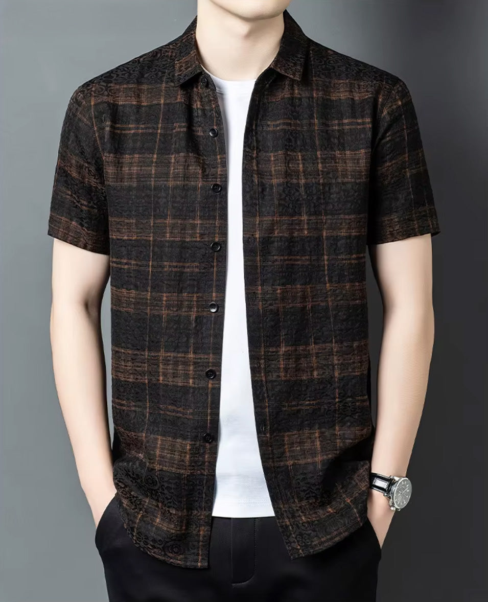 Men's unbuttoned graphite silk jacquard shirt with a cognac check pattern, worn by a man with hands relaxed in trousers pockets, from Borcelleclothes.