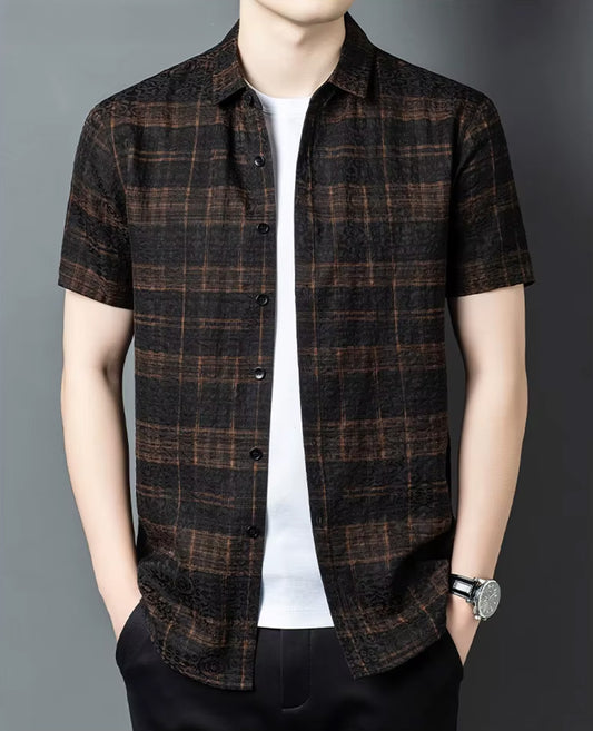 Men's unbuttoned graphite silk jacquard shirt with a cognac check pattern, worn by a man with hands relaxed in trousers pockets, from Borcelleclothes.