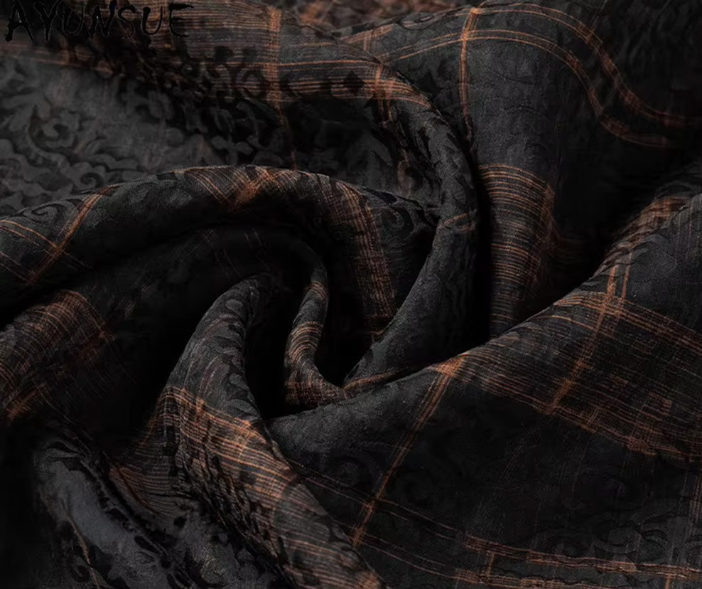 Intricate wave-folded texture of a men's double-layer jacquard silk shirt in Baroque Graphite with a structural cognac check framework, from Borcelleclothes.
