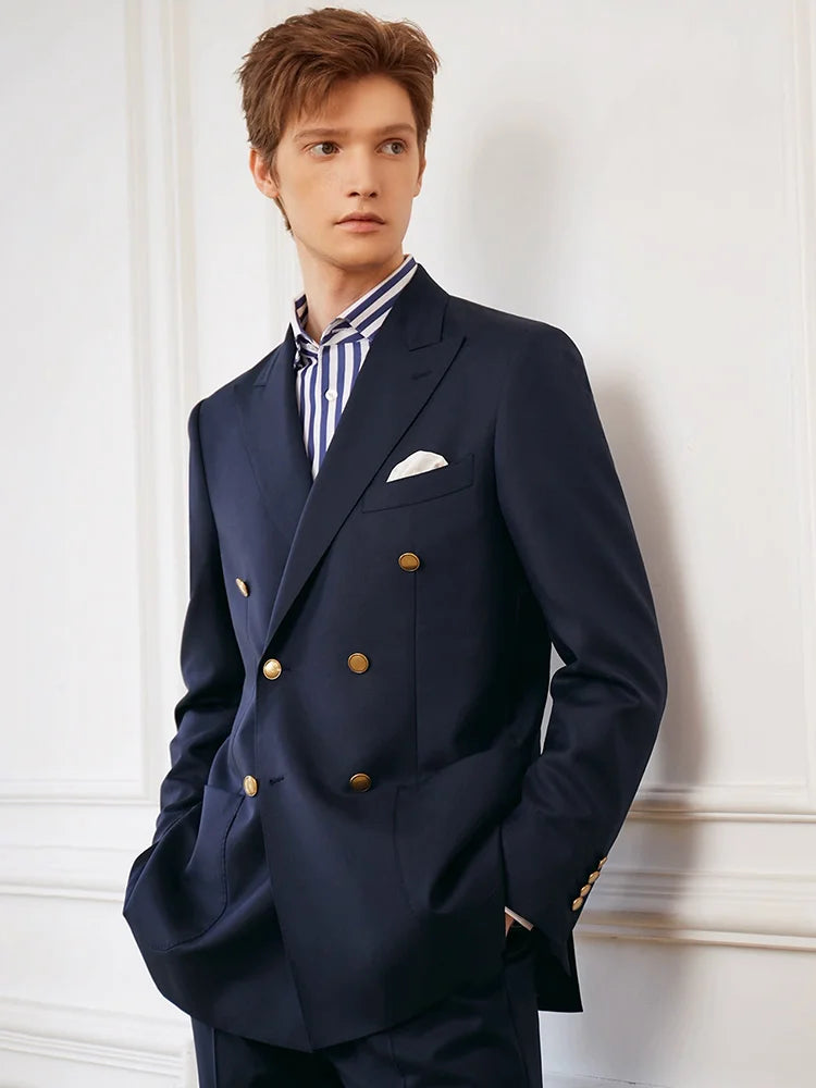Model in the Borcelleclothes Men's VBC Navy Blue Wool Suit with Brass Accents, standing with both hands in pant pockets, emphasizing the slim-cut pant and tailored fit.