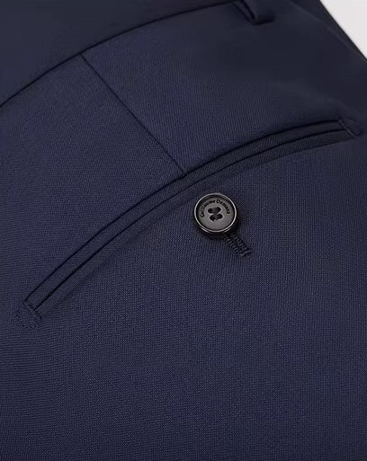 The back double-welt pocket on the pants of the Borcelleclothes Men's VBC Navy Blue Wool Suit with Brass Accents, balancing practicality with clean design.