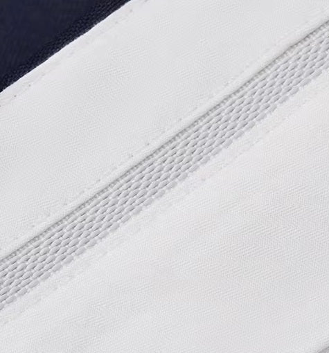 The gripper tape inside the waistband of the pants from the Borcelleclothes Men's VBC Navy Blue Wool Suit with Brass Accents, designed to keep shirts securely tucked.