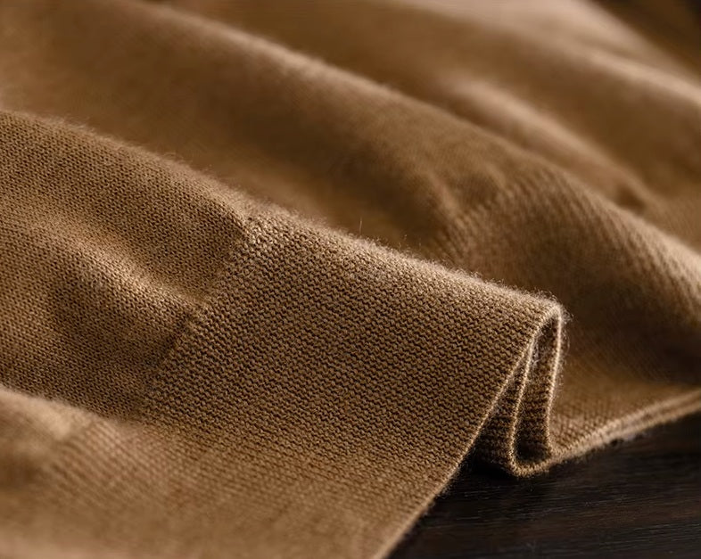 Flat technical view of the shape-retentive 1x1 ribbed bottom hem on the Amber Resin cashmere pullover — From Borcelleclothes.