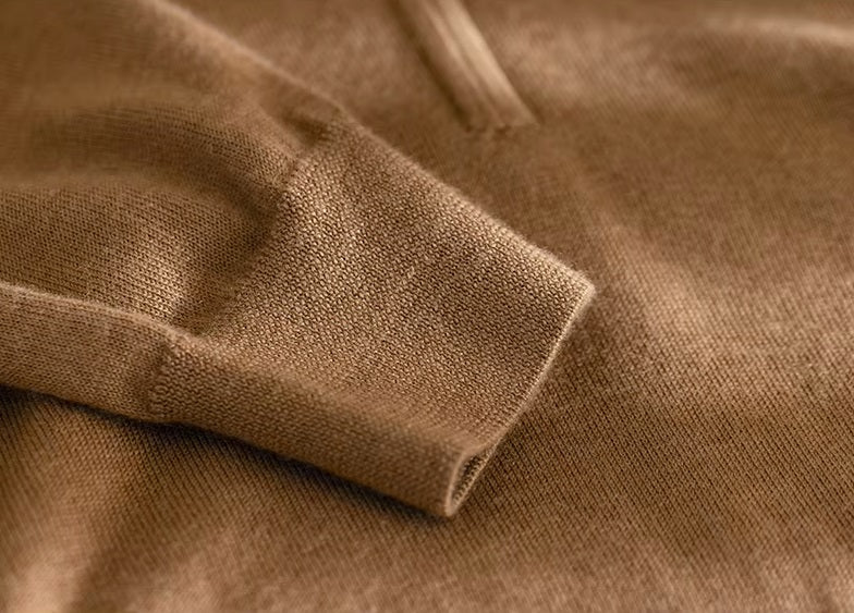 Close-up of the resilient knitted sleeve cuff in Amber Resin fine-gauge worsted cashmere — From Borcelleclothes.
