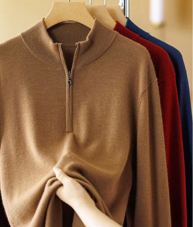 Hand holding the Amber Resin worsted cashmere knit to demonstrate its smooth, dry handfeel and tight yarn twist — From Borcelleclothes.