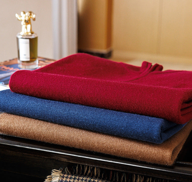 Neatly folded stack of fine-gauge worsted cashmere pullovers showcasing Ceylon Sapphire, Cut Ruby, and Amber Resin — From Borcelleclothes.