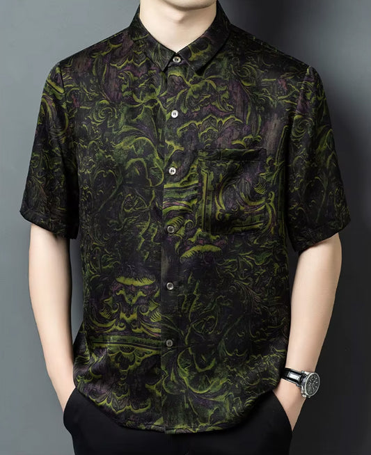 A man modeling the short-sleeve Xiangyunsha silk shirt in Film Exposure color, standing with both hands in his trousers pockets — From Borcelleclothes.