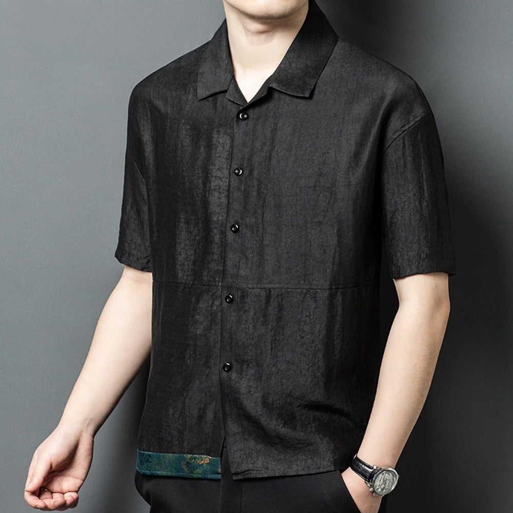 A man with his arm bent, capturing how the matte Xiangyunsha silk naturally creases and moves against the skin in high summer heat — From Borcelleclothes.