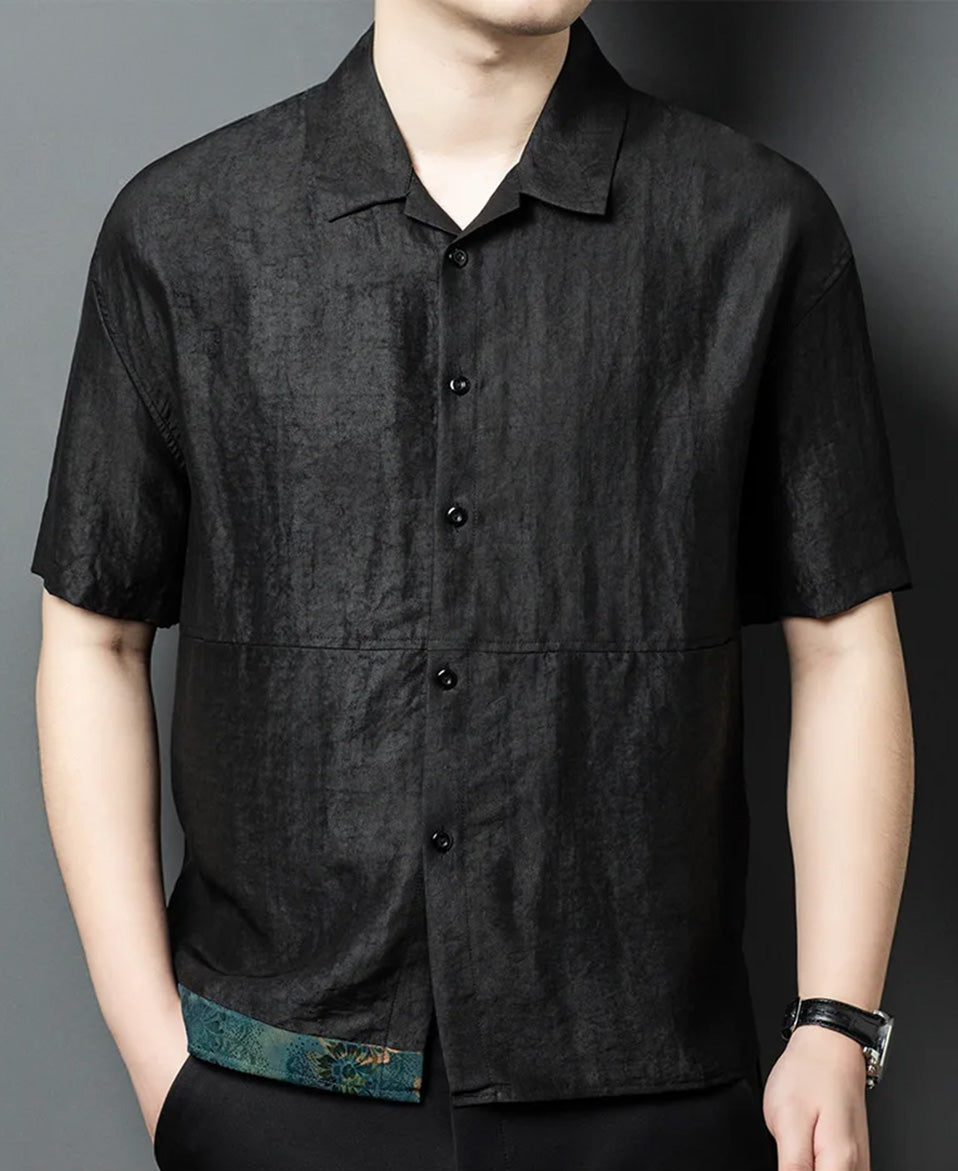 A man standing with his hand in his trousers pocket, showcasing the fit and texture of the Parchment Graphite Xiangyunsha silk shirt-jacket — From Borcelleclothes.