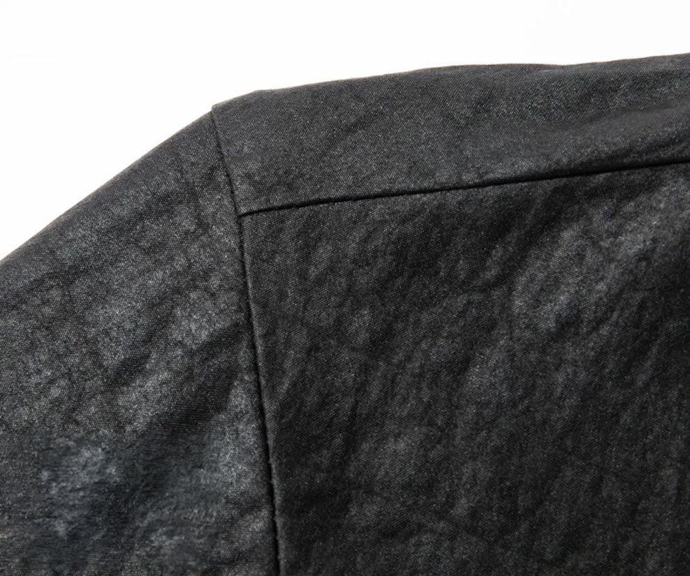 Close-up of the clean, dropped shoulder line on a structured matte black silk overshirt. From Borcelleclothes.