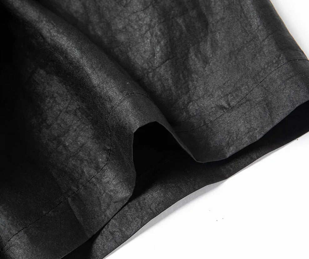 Detail of the wide, short sleeve construction on a minimalist black Xiangyunsha silk shirt. From Borcelleclothes.
