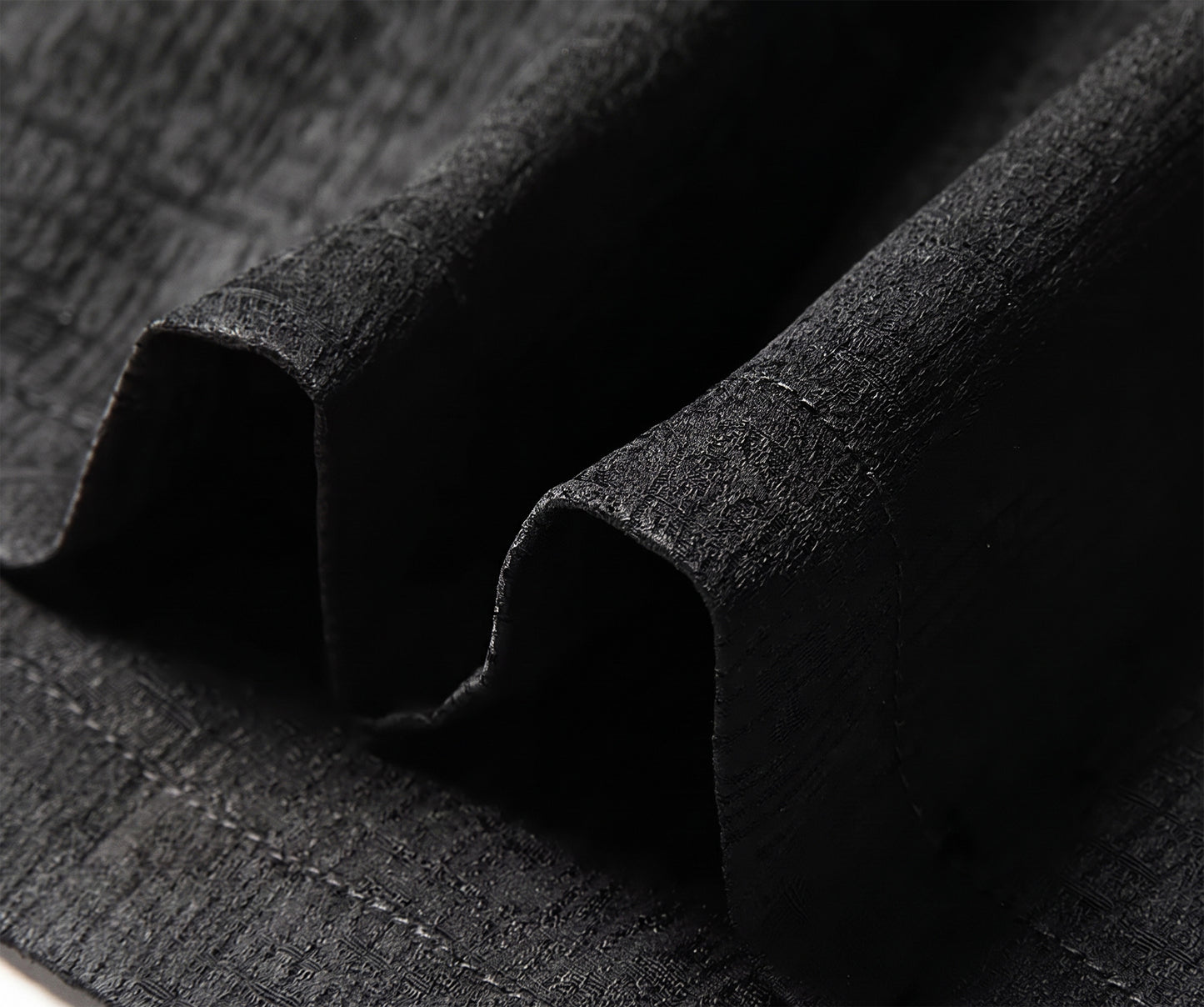 Close-up of the straight bottom hemline of the dense Mulberry silk shirt, showing the clean factory stitching and the weight-bearing nature of the multi-dimensional textile - From Borcelleclothes.