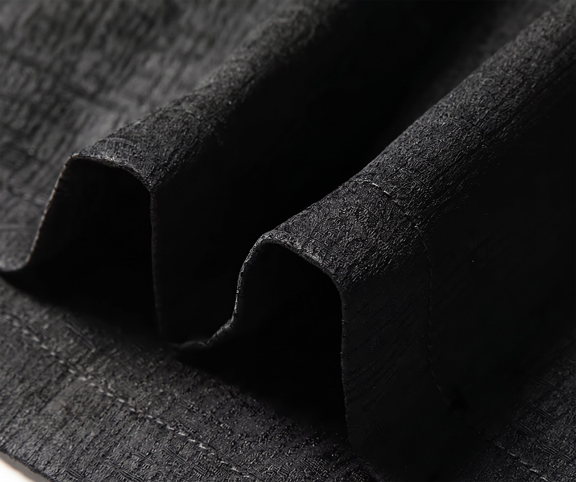 Close-up of the straight bottom hemline of the dense Mulberry silk shirt, showing the clean factory stitching and the weight-bearing nature of the multi-dimensional textile - From Borcelleclothes.