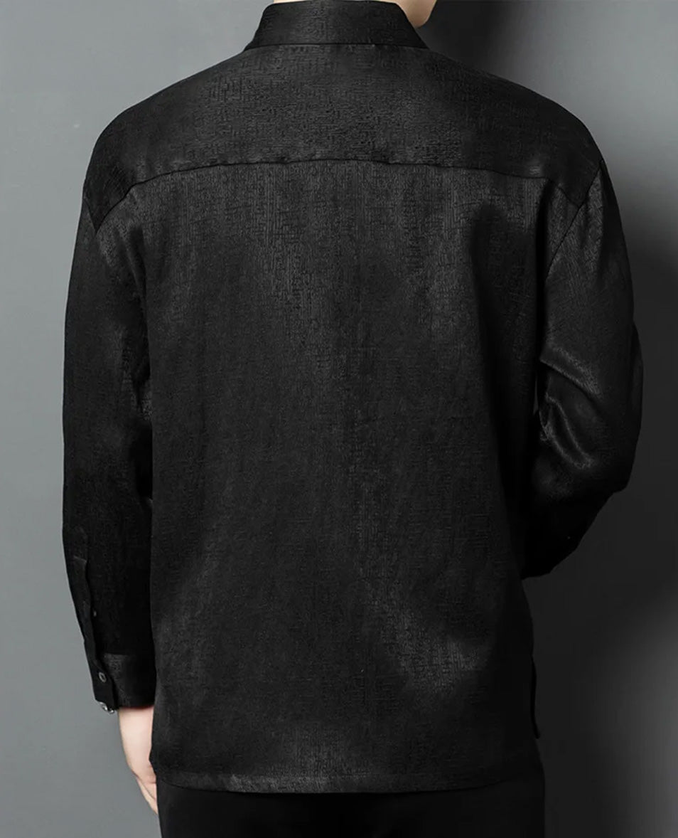 Back view of a model wearing the structured graphite-black silk shirt, highlighting the clean masculine silhouette and the permanent tactile pattern of the high-density jacquard weave - From Borcelleclothes.