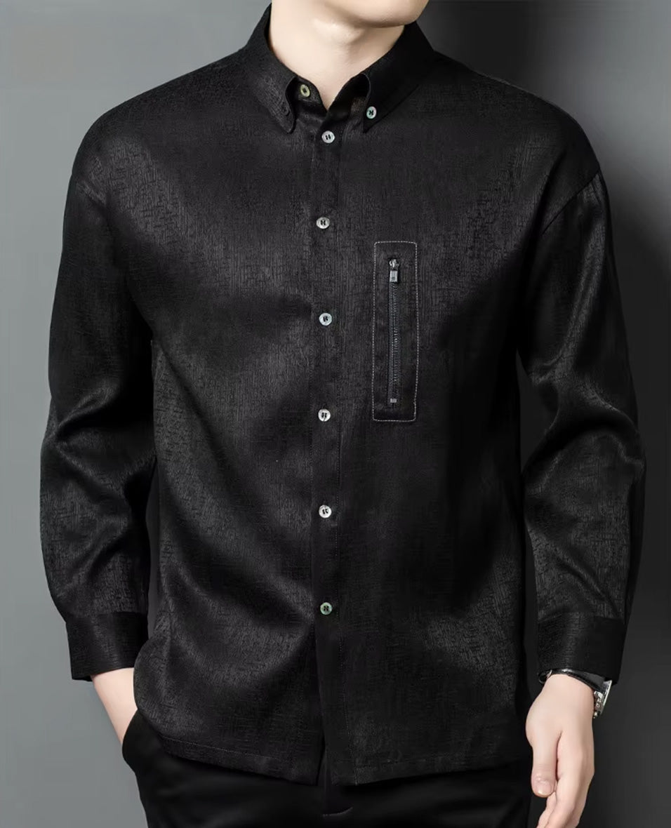 Front view of a model in a heavyweight black silk jacquard shirt with hands placed in trousers pockets, emphasizing the straight fit and geometric fabric texture - From Borcelleclothes.