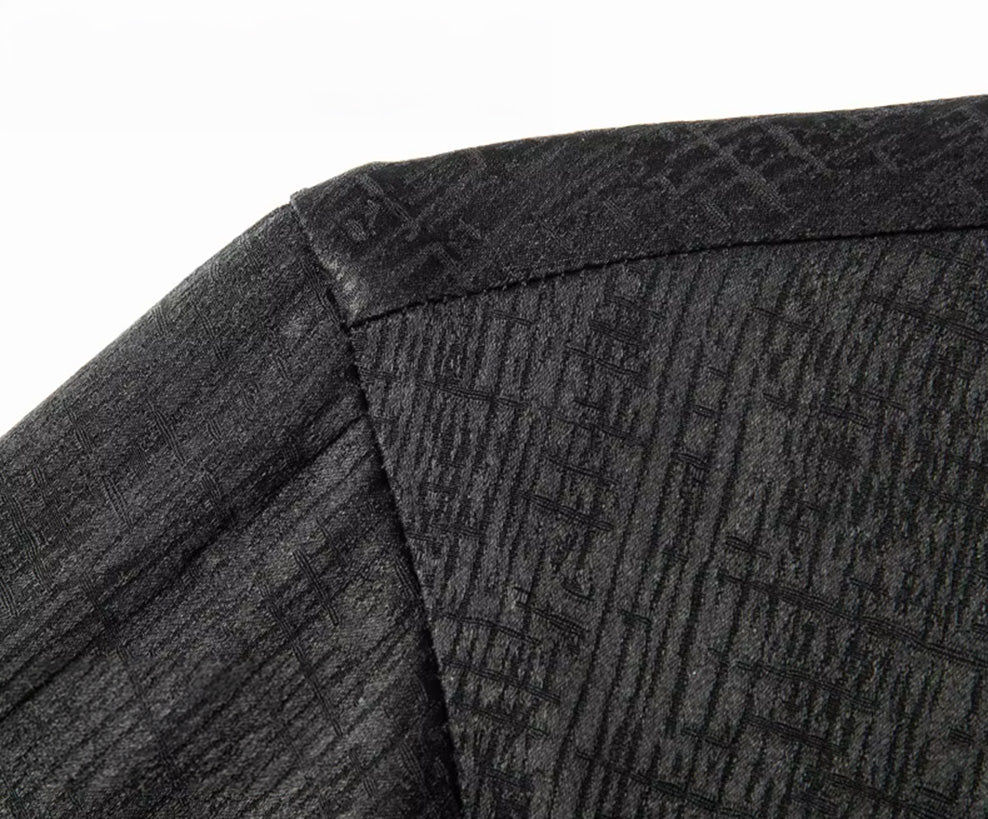 Close-up focusing on the dropped shoulder seam of the men's black silk shirt, demonstrating how the substantial double-weave fabric holds its shape and structure - From Borcelleclothes.