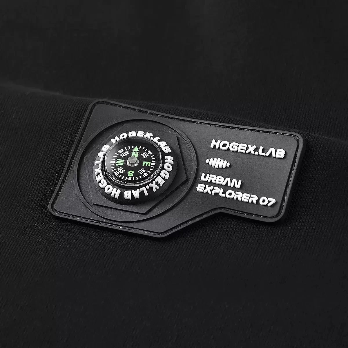 Rubberized chest patch with stylized compass on the Onyx men's compass sweatshirt. From Borcelleclothes.