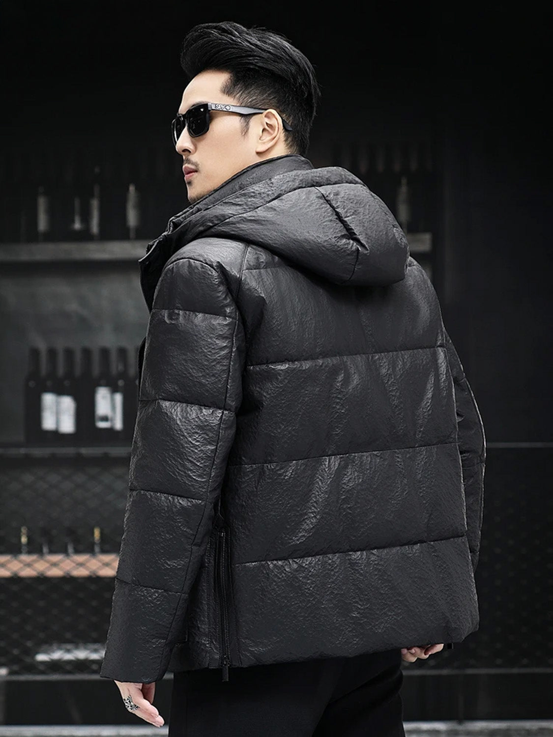 Back view of the men’s compressed down sheepskin jacket in Onyx, showcasing hood and silhouette — From Borcelleclothes.
