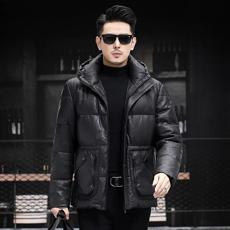Men’s compressed sheepskin down jacket in Onyx, with curved side patch pockets, decorative zippers, and sculptural collar-hood design.  —  From Borcelleclothes.