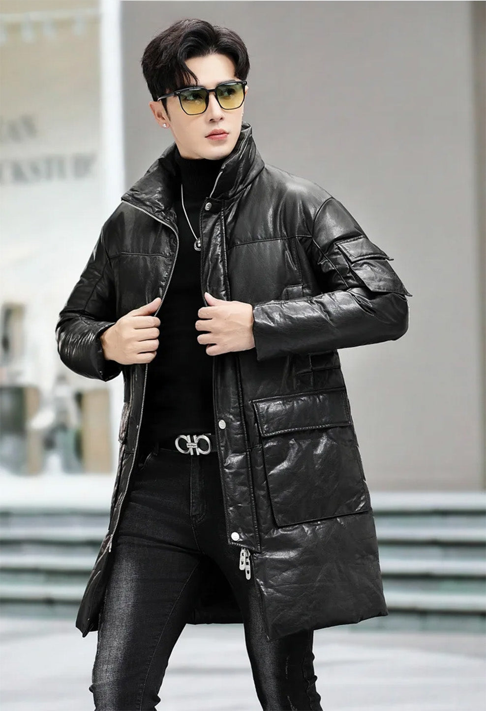 Unzipped cowhide coat in Onyx, model holding the side edges — From Borcelleclothes.