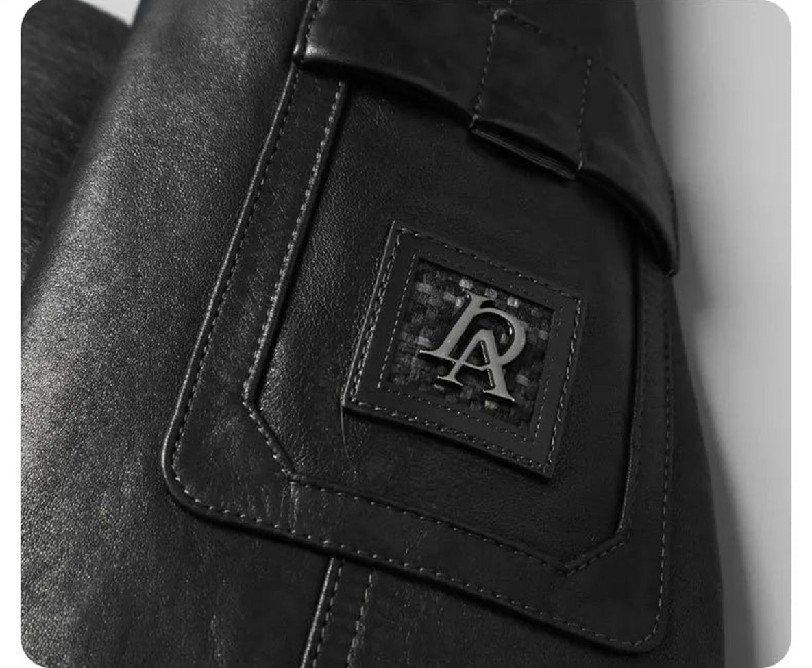 Left sleeve patch pocket with flap and woven-leather badge with metal initials on the Onyx cowhide coat. — From Borcelleclothes.