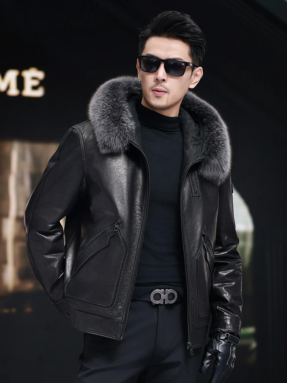 Unzipped cowhide coat in Onyx, model with one hand behind, showing fox fur hood and front piping. — From Borcelleclothes.