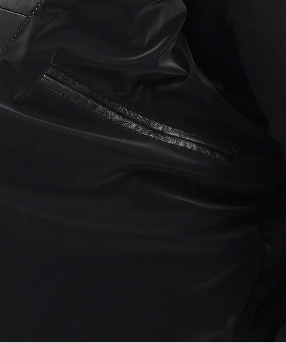 Interior lining of the Onyx cowhide down coat with soft tonal padding and glossy texture. — From Borcelleclothes.