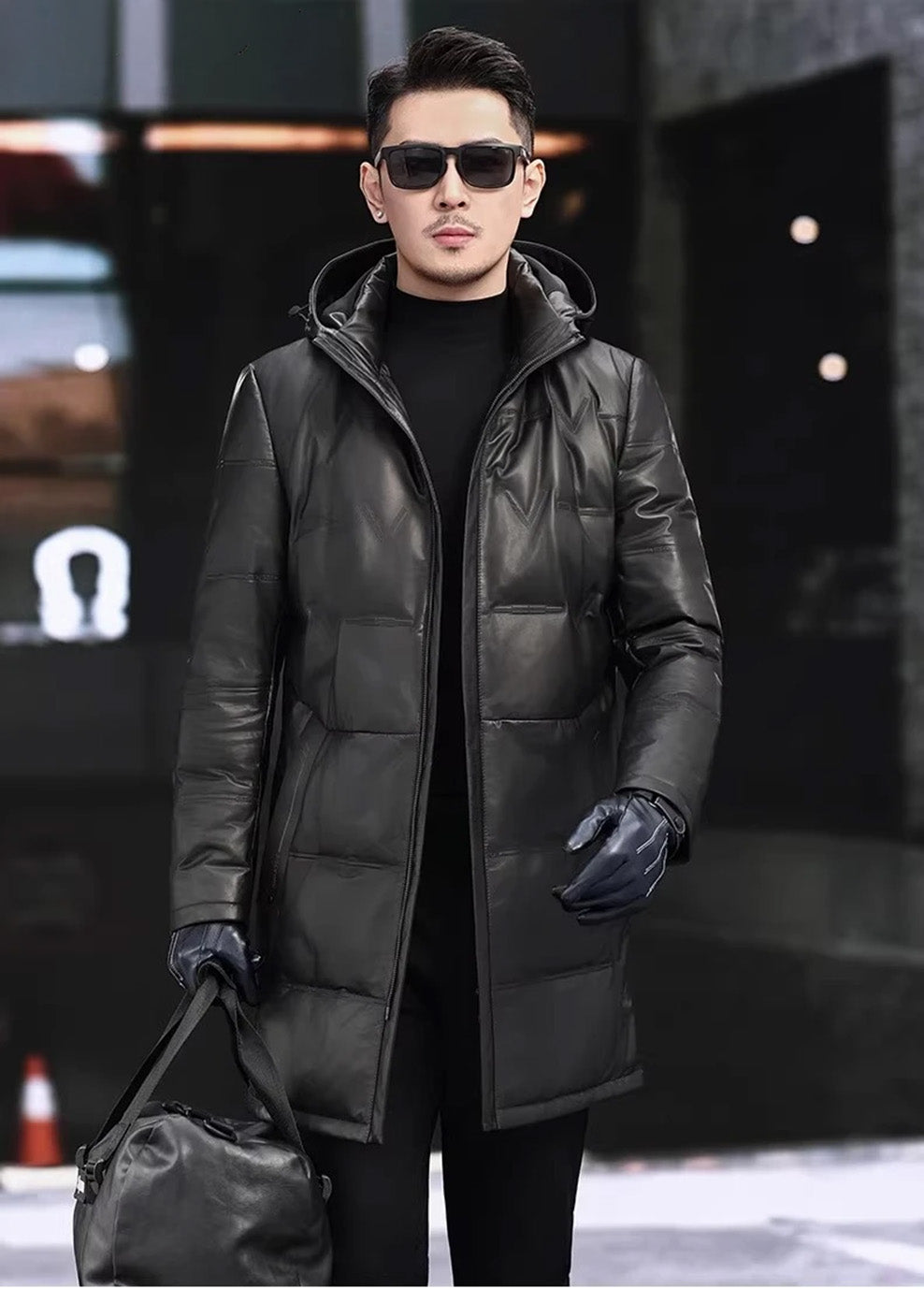Model wearing an Onyx cowhide down coat, holding an oversized bag — From Borcelleclothes.