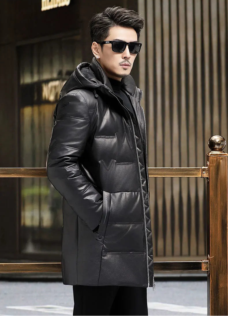 Three-quarter side view of model in Onyx cowhide down coat with sculptural hood and tonal pattern. — From Borcelleclothes.