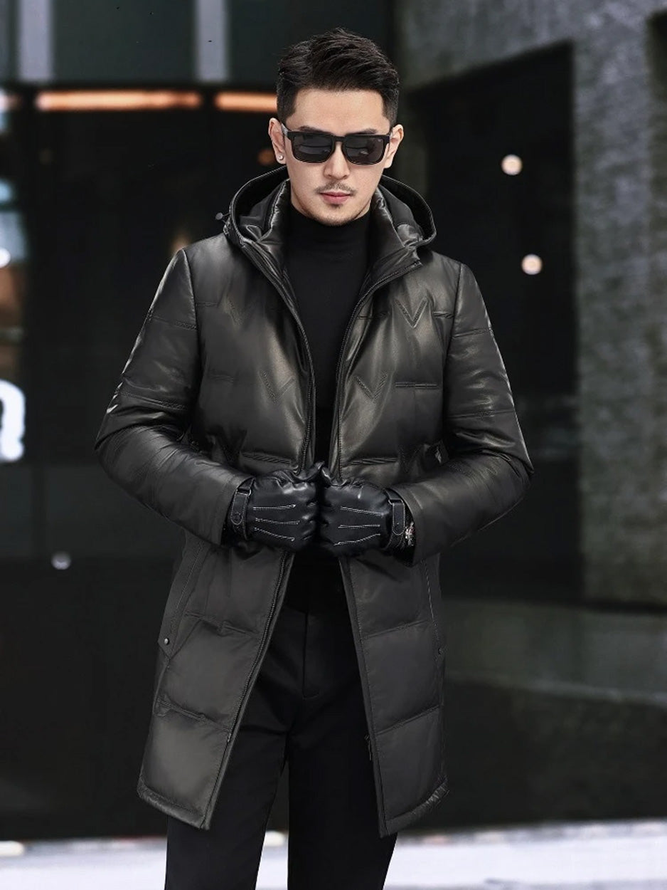 Model holding the unzipped front of the Onyx cowhide down coat, revealing interior volume and embossed outer shell. — From Borcelleclothes.