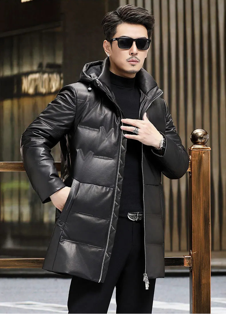 Model holding the unzipped front of the Onyx cowhide down coat, revealing interior volume and embossed outer shell. — From Borcelleclothes.